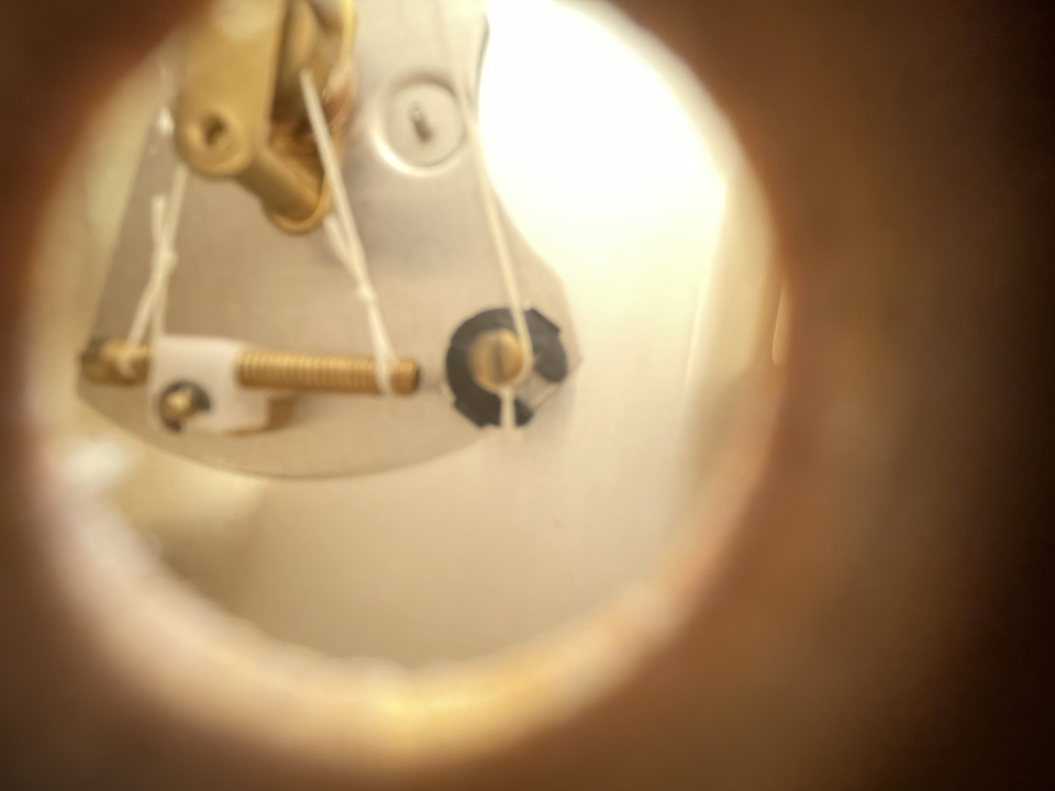 &ldquo;Turning the calibration screw on the back of a wooden sauna hygrometer&rdquo;